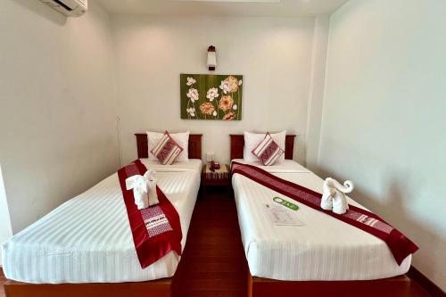 Ένα ή περισσότερα κρεβάτια σε δωμάτιο στο Sawadeelanna Hotel