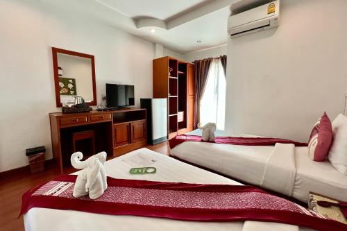 Ένα ή περισσότερα κρεβάτια σε δωμάτιο στο Sawadeelanna Hotel