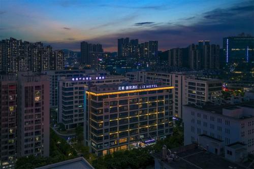 a lit up building in a city at night at Mehood Lestie, Guangzhou Huangpu Baoneng Performing Arts Center in Guangzhou