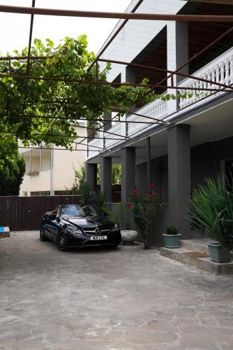 a black car parked in front of a house at Villa Aragvi in Mtskheta