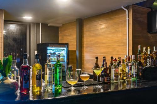 a bar with a bunch of bottles and glasses at Seaphere Pattaya Hotel by Elite Suites in Na Jomtien