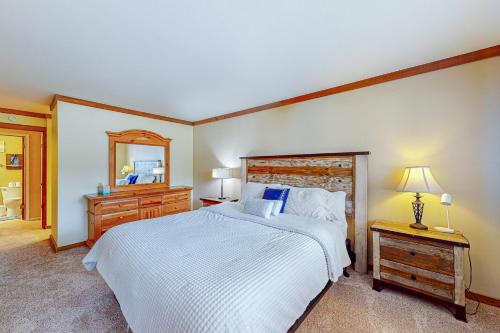 a bedroom with a bed and a dresser and a mirror at Mountainback 35 in Mammoth Lakes