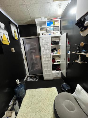 a room with a refrigerator and a room with a rug at Managa-naga Room1204 near abu dhabi mall in Abu Dhabi