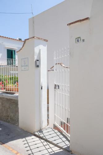 a white gate in front of a white house at Casa Giuliani Capri in Capri