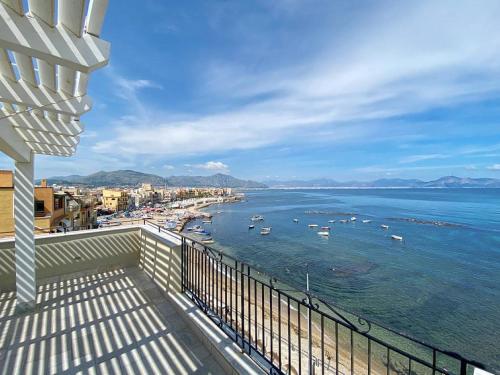 a balcony with a view of the ocean with boats at Solemar Sicilia - Casa Tramonto in Bagheria