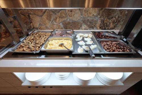 a buffet line with many different types of food at Hotel Sierra de Cazorla & SPA 3* in Cazorla