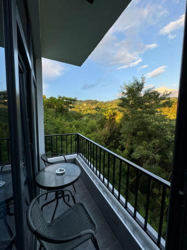 a balcony with a table and chairs and a view at Veranda White House in Batumi