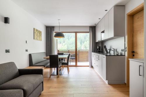 a living room with a couch and a table at Apparthotel Sonnwies in Selva dei Molini