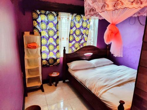 Ένα ή περισσότερα κρεβάτια σε δωμάτιο στο Amahoro Guest House