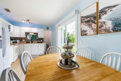 a kitchen and dining room with a wooden table and chairs at Charming 3BR Home with Free Parking & Game Room in Panama City