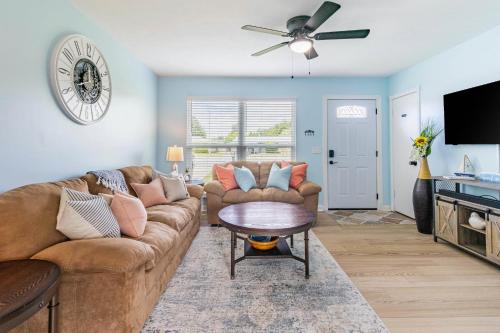 a living room with a couch and a ceiling fan at Charming 3BR Home with Free Parking & Game Room in Panama City