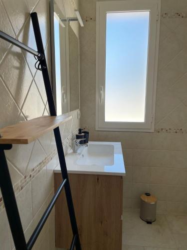 a bathroom with a sink and a window at Agriturismo Le Paesane in Melendugno