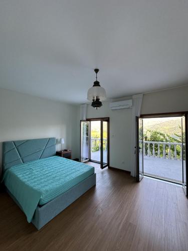 a bedroom with a bed and sliding glass doors at Quinta da Touça in Baião