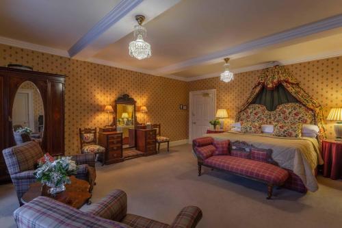 a large bedroom with a bed and a living room at Glenapp Castle in Ballantrae