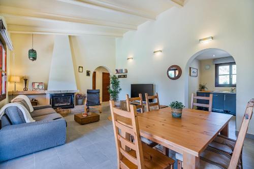 a living room with a wooden table and a couch at Can Singala 46 in Port de Pollensa