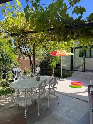 a table and chairs and an umbrella on a patio at Casa da Alicinha - Férias no Douro in Baião