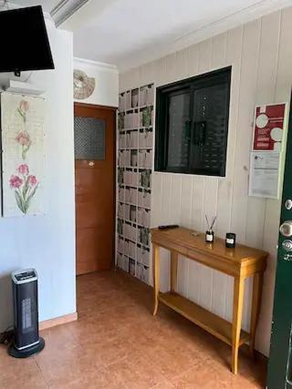 a room with a wooden table and a window at Casa da Alicinha - Férias no Douro in Baião