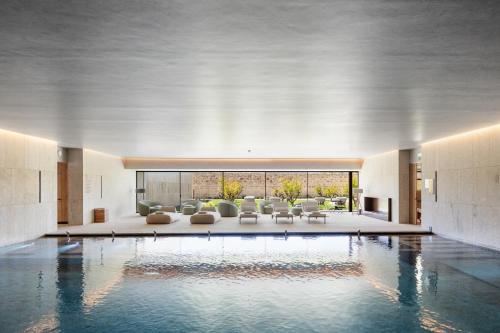 a lobby with a swimming pool in a building at The Lince Santa Clara in Vila do Conde