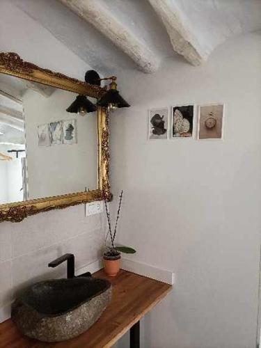 a bathroom with a stone sink and a mirror at El mirador del río de Arnedillo in Arnedillo