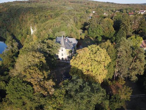 an aerial view of a house in the forest at Grange du château in Boussières