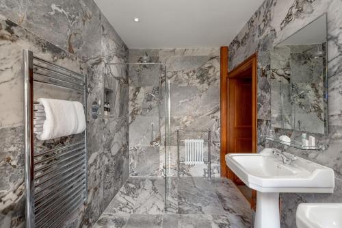 a bathroom with a sink and a shower at Glencoe House in Glencoe