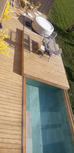 - une vue sur la piscine avec un frisbee sur une terrasse dans l'établissement Gîte romantique cosy et reposant, à Bainville-sur-Madon