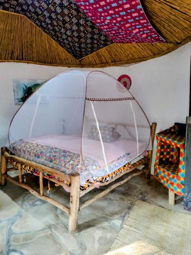 Ένα ή περισσότερα κρεβάτια σε δωμάτιο στο Red Rocks Rwanda - Campsite & Guesthouse