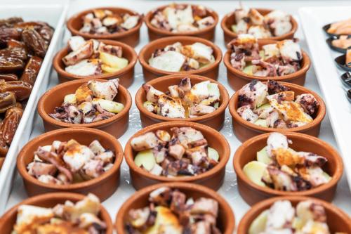 a bunch of small cups of food on a table at Best Club Vacaciones Pueblo Indalo in Mojácar