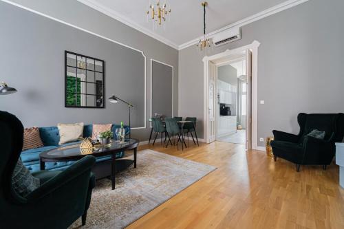a living room with a couch and a table at Heart of City in Budapest