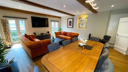 a living room with a couch and a table at The Coach House - Traveller Award 2026 - A stunning three-storey property nestled in the heart of the lanes complete with secure private parking in Brighton & Hove