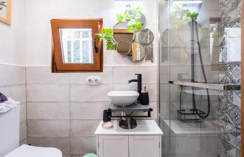 a bathroom with a sink and a toilet in it at La Puerta Verde in Mataelpino