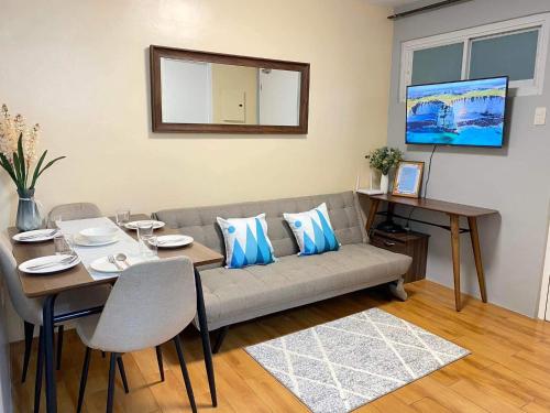 a living room with a couch and a table at Seawind Condominium 2 Bedroom Near Samal and Airport in Davao City