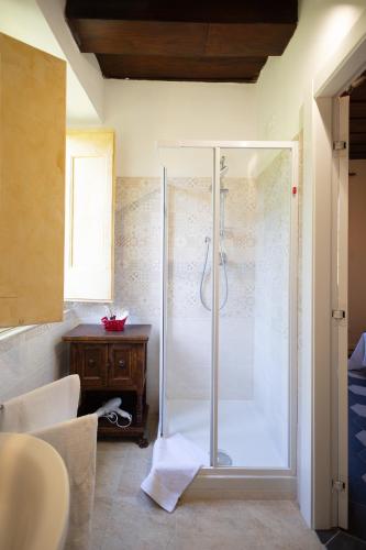 a bathroom with a shower with a glass door at Tenuta dell'Inviolata Guest House in Velletri