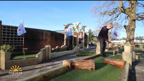 two men are playing a game in a cemetery at Marigold lodge 8 at Oakdene Forest Park in Saint Leonards