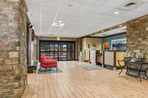 a lobby with a red chair and a brick wall at Hampton Inn & Suites Colorado Springs-Air Force Academy/I-25 North in Colorado Springs