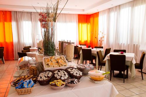 a table with food on it in a restaurant at Hotel President Pomezia in Pomezia