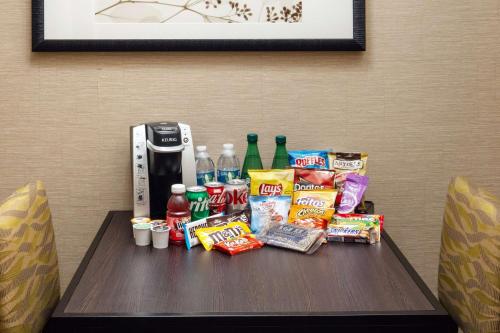 a table with snacks and drinks on top at Embassy Suites Saint Louis - Downtown in Saint Louis