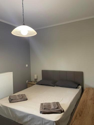 a bedroom with a bed with two towels on it at Village Experience in Xanthi