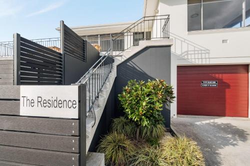 a building with a sign that reads the residence at Residence at 165 Great for large groups Sleeps 11 in Hobart