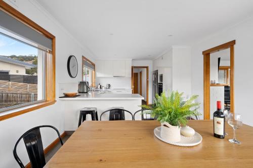 a kitchen and dining room with a wooden table at Residence at 165 Great for large groups Sleeps 11 in Hobart