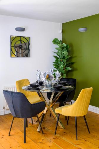 a dining room with a table and four chairs at Durham City, Peaceful, Sauna, Free Parking in Durham
