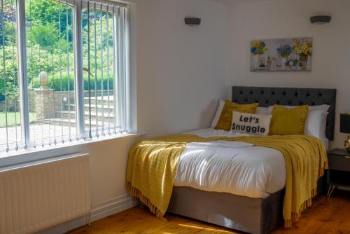 a bedroom with a bed with a yellow blanket on it at Durham City, Peaceful, Sauna, Free Parking in Durham