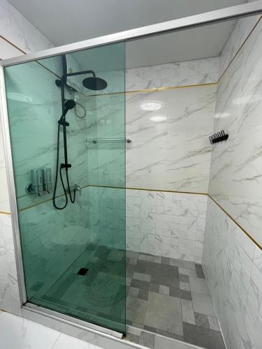 a shower with a glass door in a bathroom at View Talay6 Mark Apartments in Pattaya