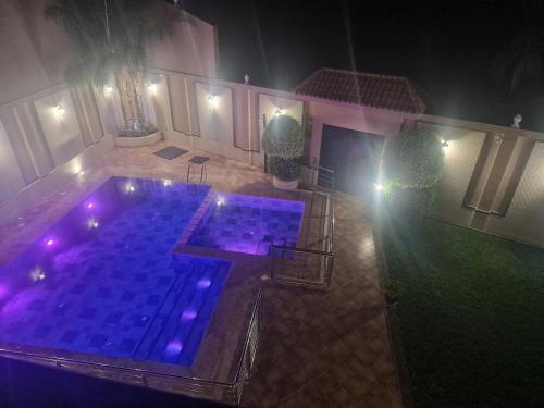 an overhead view of a swimming pool at night at Villa Fatma in Haraka