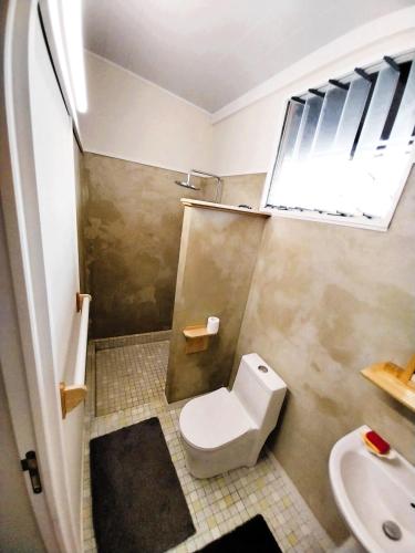 a small bathroom with a toilet and a sink at TAHITI - Matavai Bay Spirit in Arue