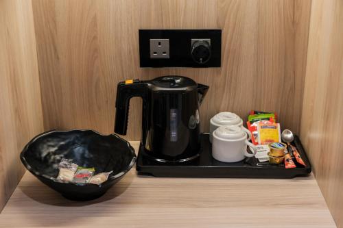 a coffee maker and a bowl on a counter at Abacus Suites in Ayia Napa