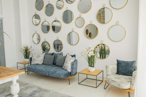 a living room with mirrors on the wall at Abacus Suites in Ayia Napa