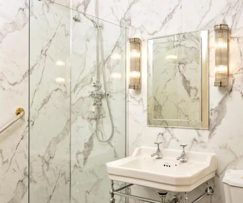 a bathroom with a sink and a shower at Castle Hotel in Taunton