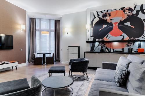 a living room with a couch and a table at H15 Boutique Hotel, Warsaw, a Member of Design Hotels in Warsaw