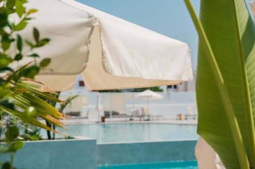 a close up of a swimming pool with an umbrella at Abacus Suites in Ayia Napa